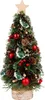 A small, decorated Christmas tree on a white background. Voir les images du produit