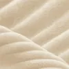 A close-up, abstract view of a textured, beige fabric with a quilted pattern. Produktbild-Vorschau