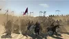 A large group of soldiers on horseback charging across a dusty battlefield, with flags flying. Náhled obrázku produktu