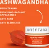 A marketing image for Orientana Ashwagandha face cream, featuring text highlighting benefits and a product jar next to a dried plant pod. Produktbild-Vorschau