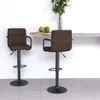 Two brown bar stools in a modern setting with a counter and a vase of plants. Produktbild-Vorschau