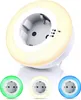 A white LED night light with a built-in socket, displaying different color options. Voir les images du produit