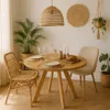 A dining table set with chairs, plants, and decor in a bright, natural-toned room. Produktbild-Vorschau