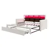 A beige upholstered sofa bed with its mattress frame extended and two storage drawers pulled out. The headboard has built-in shelves and LED lighting that is illuminated in red. Anteprima dell’immagine prodotto