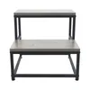 A two-step stool with a gray wood-grain finish and black metal frame, shown against a white background. Náhled obrázku produktu