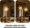 A dining room setting with star-shaped paper lanterns hanging above a wooden table and chairs. Podgląd zdjęcia produktu