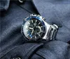 A close-up shot of a men's wristwatch with a metal band, resting on a dark blue fabric surface. Anteprima dell’immagine prodotto