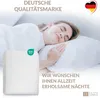 A woman sleeping peacefully on a pillow, with a product package in the foreground and marketing text. Produktbild-Vorschau