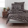 A bed with bedding set on a wooden nightstand. Produktbild-Vorschau