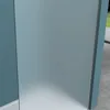 A close-up view of a shower enclosure, showing the frosted glass panel and its frame. Produktbild-Vorschau