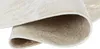 A close-up view of a rolled-up rug, showing the texture and pattern of both the top and bottom surfaces. Anteprima dell’immagine prodotto