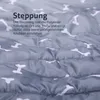 Close-up of a quilted fabric with a bone pattern, featuring German text describing the quilting. Podgląd zdjęcia produktu
