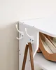 A close-up shot of a white shoe rack with brown shoes and a brown handbag on it. Anteprima dell’immagine prodotto