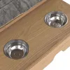 Close-up view of two stainless steel bowls embedded in a wooden surface, with a gray fabric item in the upper left corner. Produktbild-Vorschau
