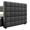 A close-up view of a gray upholstered bed frame with a tufted headboard. Produktbild-Vorschau