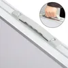 A close-up view of a handle on a folding table, with a hand gripping it. Anteprima dell’immagine prodotto