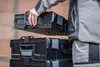 A person is stacking toolboxes. Náhľad obrázku produktu