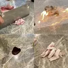 A collage of four images showing different stages of food preparation, including chopping meat, food on fire, a spill of dark liquid, and sliced meat. Produktbild-Vorschau
