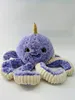 A plush toy octopus with a narwhal horn is displayed against a white background. Produktbild-Vorschau
