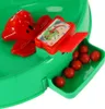 Close-up of a children's arcade game with red frogs and small red balls. Náhled obrázku produktu