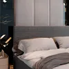 A close-up view of a bed with pillows and a duvet. Produktbild-Vorschau