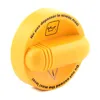 A yellow oil filler cap with text and symbols. Náhled obrázku produktu