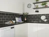 A modern kitchen counter with a sink, dishwasher, and various kitchen items. Náhled obrázku produktu