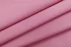 A close-up, angled view of folded pink fabric. Produktbild-Vorschau