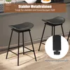 Two black bar stools are shown in a kitchen or dining area setting. A close-up inset shows the adjustable feet of one of the stools. Podgląd zdjęcia produktu