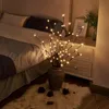 A bedroom scene with a bed, nightstand, and decorative LED branch lights in a vase. Anteprima dell’immagine prodotto