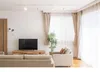 A living room with a sofa, armchair, TV, and curtains. Produktbild-Vorschau