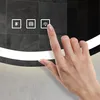 A hand is touching a touch-sensitive control panel on a mirror. Produktbild-Vorschau