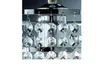 A close-up view of a chandelier with crystal pendants hanging from a silver frame. Produktbild-Vorschau