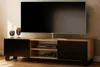 A TV stand with a TV on it, and decorative items on the side. Produktbild-Vorschau