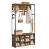 A freestanding coat rack and shoe storage unit with multiple shelves and hooks. Produktbild-Vorschau