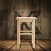 A wooden stool is placed on a wooden floor in front of a textured wall. Voir les images du produit