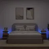 A bedroom scene with a bed, nightstands, and artwork on the wall.