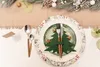 A Christmas-themed table setting with a place setting featuring a Christmas tree napkin ring, cutlery, and acorns. Produktbild-Vorschau