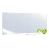 A mirror heating panel with two green apples and a power cord on a white background.