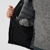 Close-up view of the inside of a jacket, showing a pocket with mittens inside. Náhled obrázku produktu