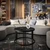 A modern living room with a curved sofa, coffee table, and abstract art. Produktbild-Vorschau