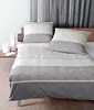 A neatly made bed with a duvet cover and pillows. Produktbild-Vorschau