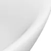 A close-up view of a white ceramic sink with a curved edge. Produktbild-Vorschau