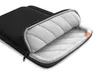 A black laptop sleeve with its zipper partially open, revealing a padded gray interior. Náhľad obrázku produktu