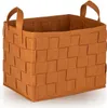 A brown woven storage basket with handles, shown from a three-quarter angle on a white background. Anteprima dell’immagine prodotto