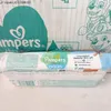 A close-up of Pampers Harmonie Aqua baby wipes packaging, with a larger Pampers package in the background. Náhľad obrázku produktu