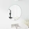 A round mirror is mounted on a white tiled wall above a modern faucet. Náhľad obrázku produktu