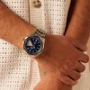 A person wearing a watch on their wrist. Produktbild-Vorschau