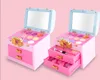 Two pink makeup cases with mirrors and makeup palettes are displayed against a pink background. Produktbild-Vorschau