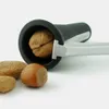 A nutcracker with a walnut inside, surrounded by other nuts on a white background. Produktbild-Vorschau